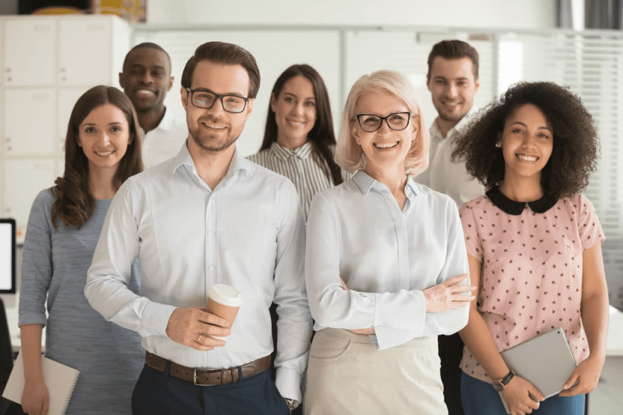 Diverse group of corporate employees in office smiling at camera