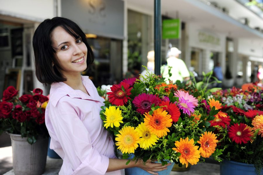 Small business owner holds floral bouquet