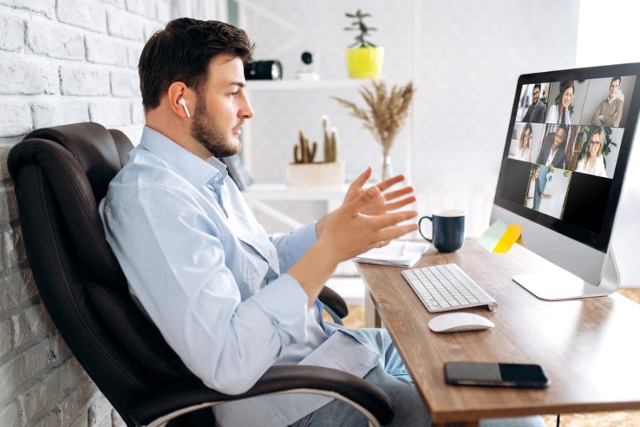 Business partners communicate via video using laptop