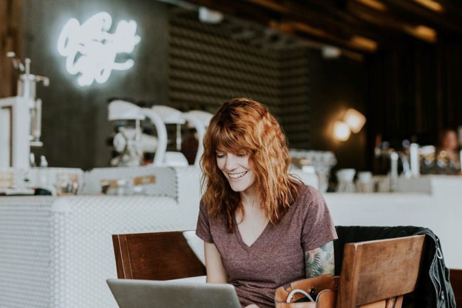 Small business owner smiles at her laptop
