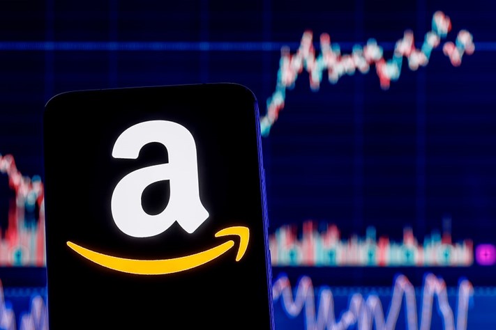Amazon logo with rising stock lines at the background