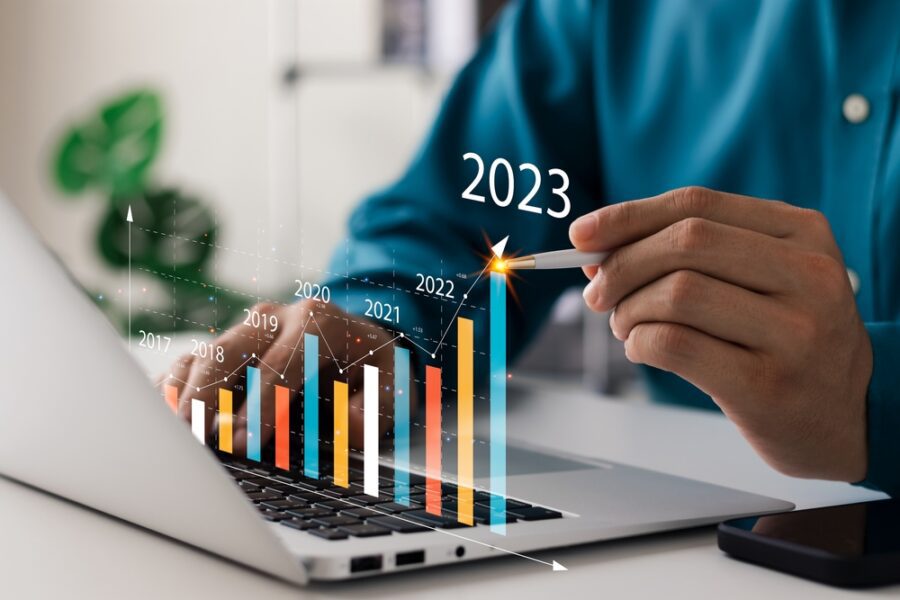 Businessman analyses profitability of working companies with digital augmented reality graphics, positive indicators in 2023, businessman calculates financial data for long-term investments.