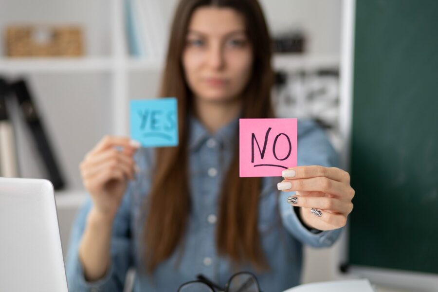 A shot of a blurry woman holding a post-it note saying NO.