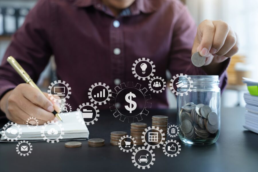 Male business owner with a calculator, pad and pen, counting money, with concept planning budget ideas floating around